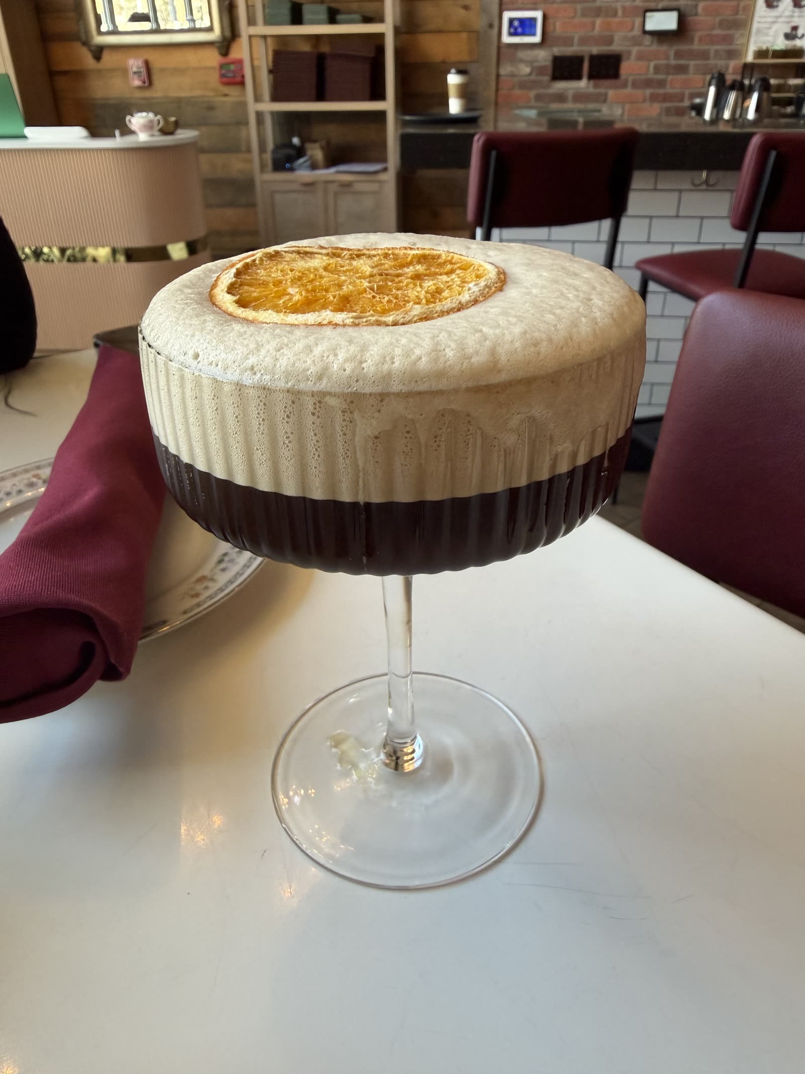 An espresso martini with a thick foam top