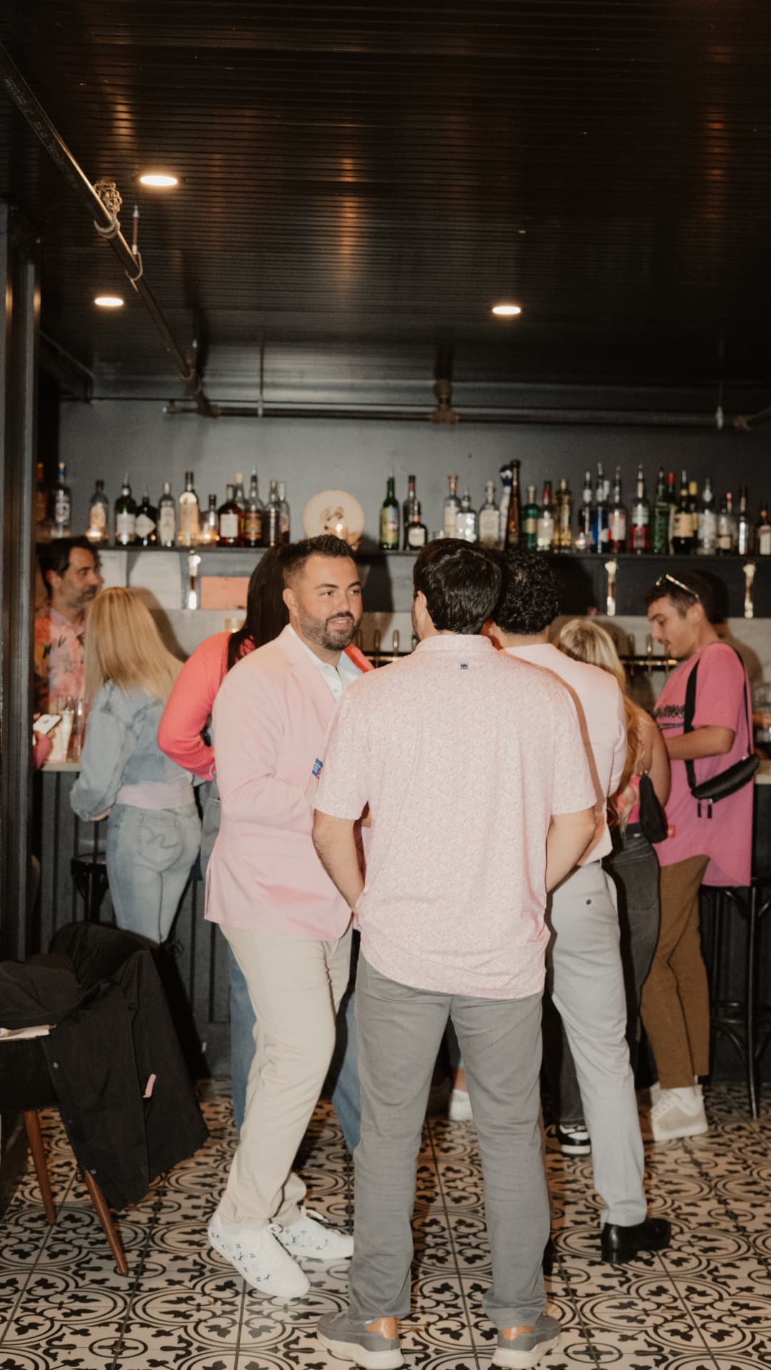 The Pink Friday crowd in pink gathered at the bar at The Night Owl